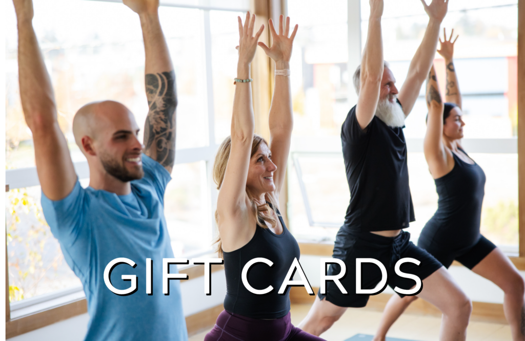 Yoga students with arms up in Crescent Lunge with text 'Gift Cards' overlaid.
