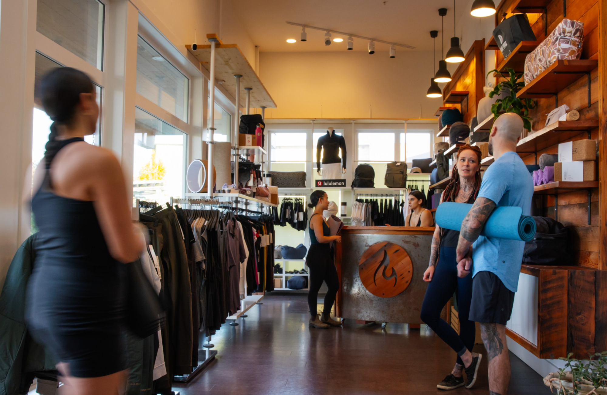 Image of Students chatting in Modo Boutique retail store at yoga studio.