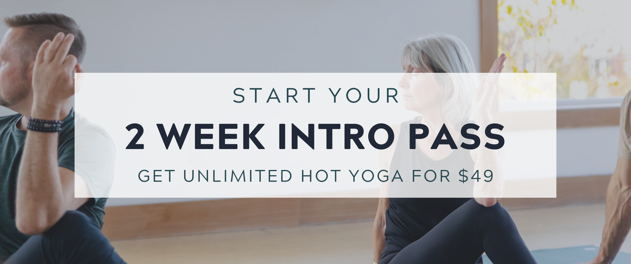 Students in seated spinal twist with text ovetop that reads 'Start your 2 Week Intro Pass: Unlimited Hot Yoga $49.